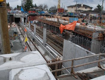 Exterior one-sided formwork to complete exterior walls. Preparation for roof slab at south end of the station. Intermediate interior walls under construction at north end of the station.