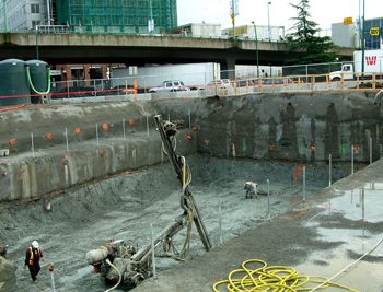 Drilling the third of six rows of soil anchors. Approximately 400 anchors were drilled to secure the exterior walls of the site.