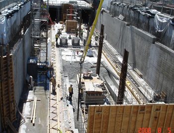 Completed exterior walls frame the platform level of the station.
