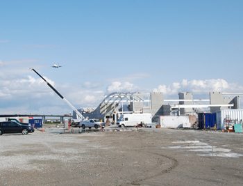 An arriving flight makes its approach to the Vancouver International Airport as it glides over Templeton Station.