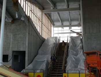 Escalator and stairway access leading to the crossover walkway, which links the inbound and outbound platforms of Templeton Station.